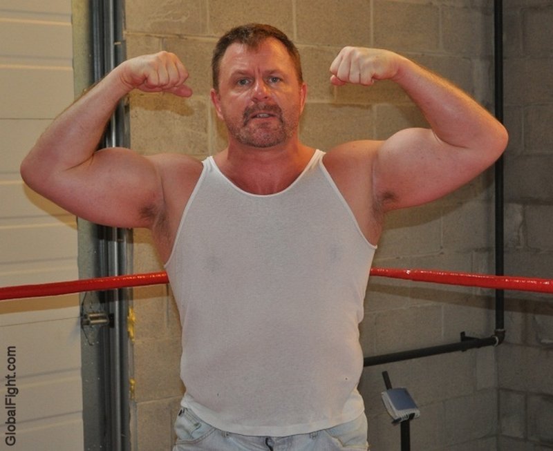 huge muscleman flexing big biceps massive guns.jpg