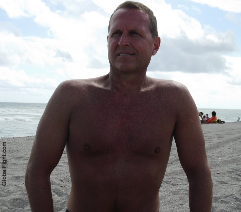 a handsome older silverdaddie man on beach.jpg