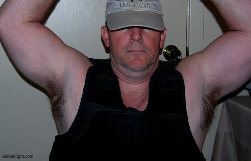 police man wearing bullet proof vest flexing muscles.jpg