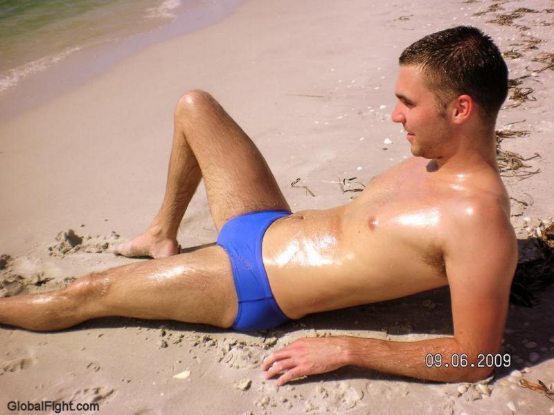 oily beach boy suntanning lotion glistening tanned skin.jpg