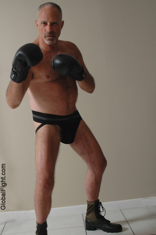 silverdaddie wearing army boots boxing gloves fighting stance.jpg