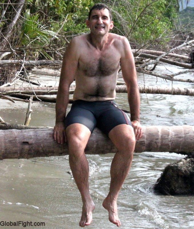 dad sitting on log island beach vacation photos.jpg