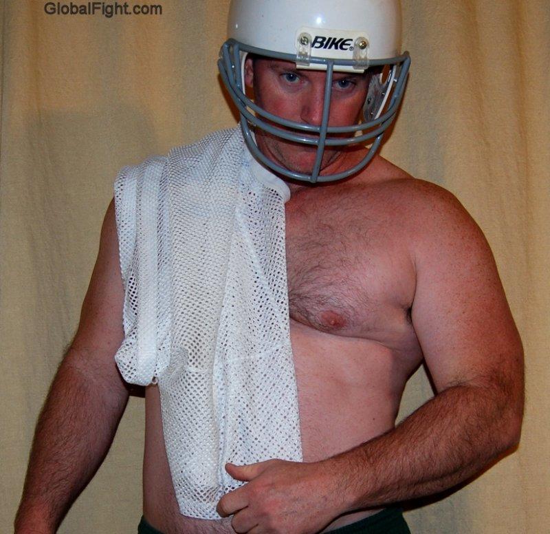 football jock wearing helmet removed shirt.jpg