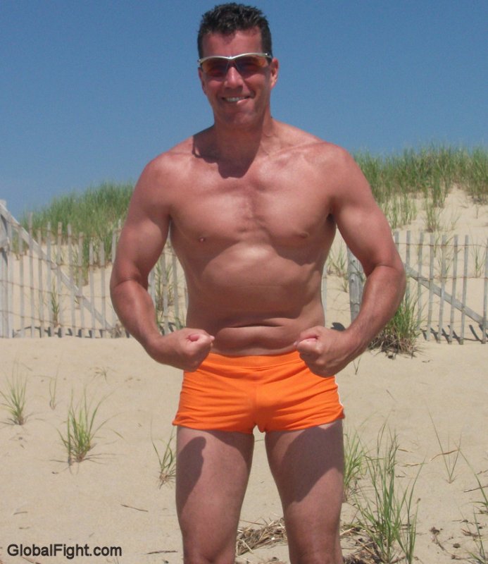 muscleman flexing chest muscles on beach.jpg