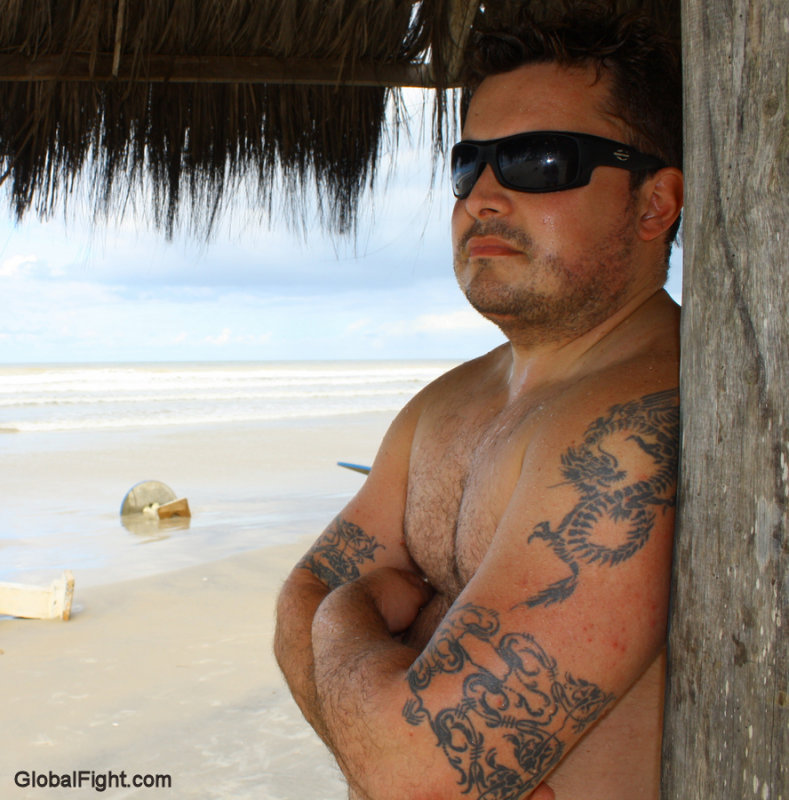 a wet sweaty beach hunk man under cabana.jpg