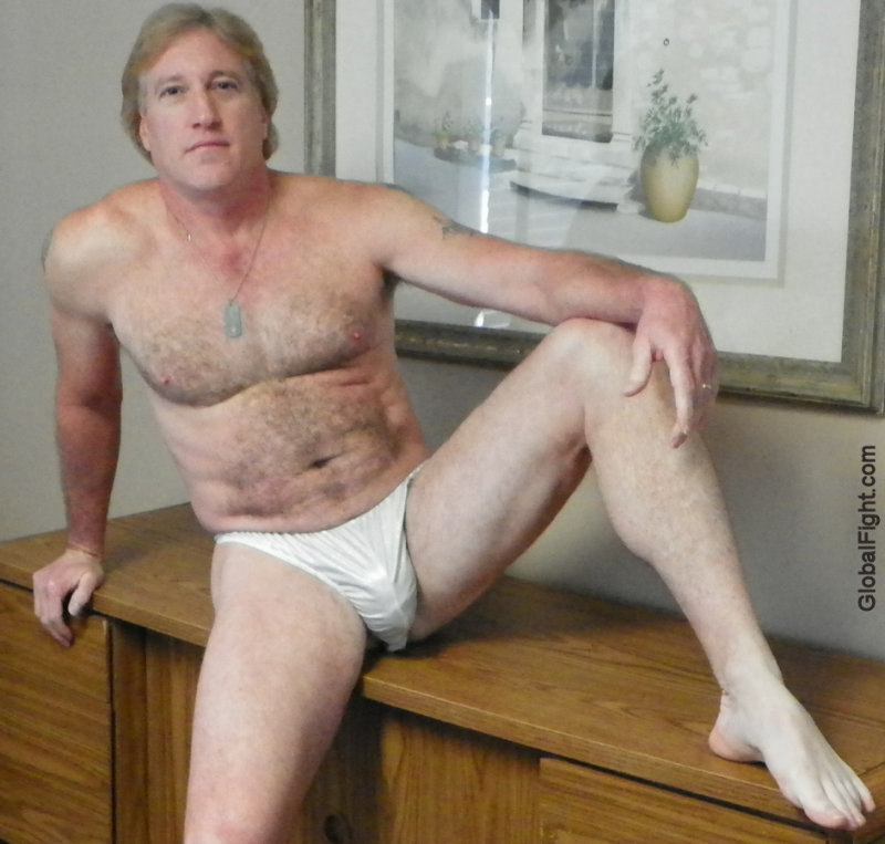 blond bombshell sitting semi nude working desk.JPG