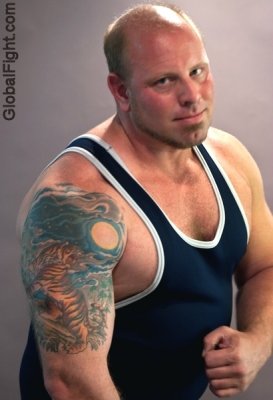 tattooed wrestler posing singlet.jpg