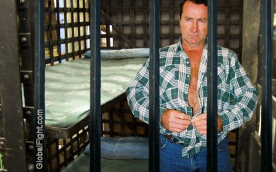caged prisoner undressing hairychest.jpg