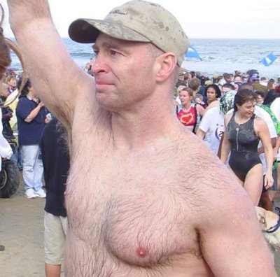 extremely hairy man jogging running event beach.jpg
