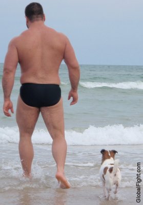 husky bear daddy walking with dog at ocean.jpg