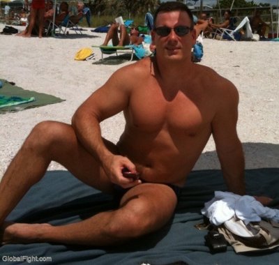 man sitting on beach suntanning bathing.jpg