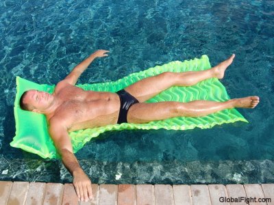 muscle man swimming rafting pool suntanning.jpg