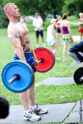 man lifting weights shirtless in park workout.jpg