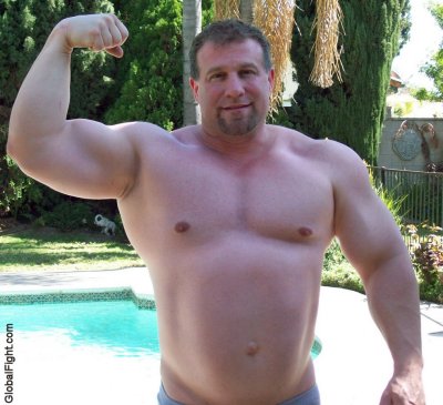 massive huge strong man powerlifter lifting big biceps.jpg