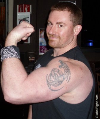 big biceps muscleman flexing tattoos arms.jpg