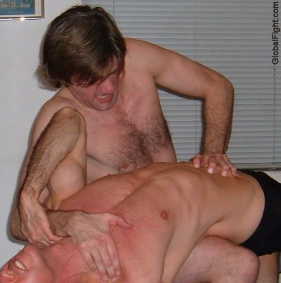 wrestler applying stomach claw hold.jpeg