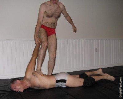 men wrestling back stomping tortured man.jpg