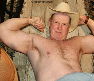 big husky cowboy flexing biceps in barn.jpeg