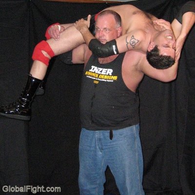 huge musclebear lifting helpless young wrestler.jpg