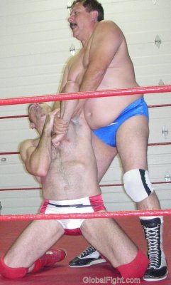 pro wrestler arm twisting locked younger hunk.jpg