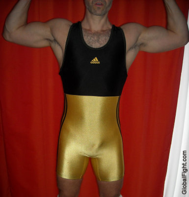 a black gold wrestling singlets man flexing hairyarms.jpg