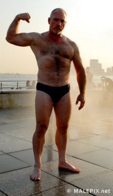 muscleman flexing boardwalk pier photos older men.jpg