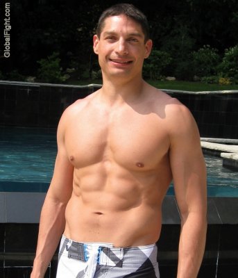 musclestud lounging poolside gay party photos.jpg