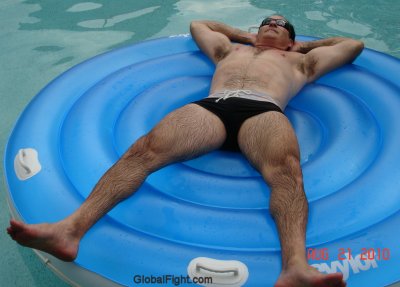 very hairylegs furry man swimming pool rafting suntanning.jpg