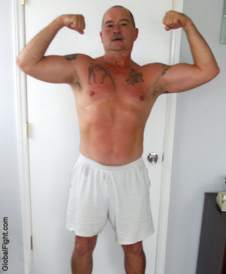 dad wearing boxer shorts flexing arms tattoos pics.jpg
