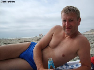 beach man lounging sandy shores young hot stud.jpg