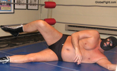heavyweight pro wrestler laying down ring mats hefty husband.jpg