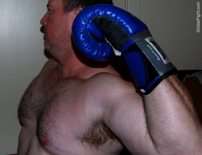 boxer wearing gloves sparring big pecs workout punching.jpg