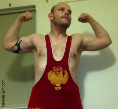 man flexing wrestling singlet tanktop hairychest gay bear.jpg