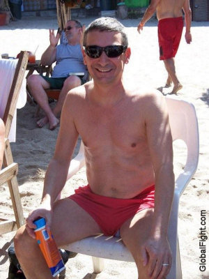 hot boy sitting on chair beach lounging suntanning.jpg
