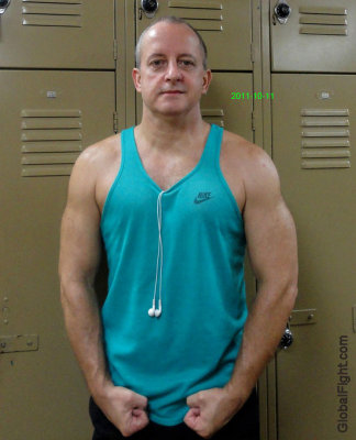 sweaty musclejock posing flexed arms in locker room gym.jpg