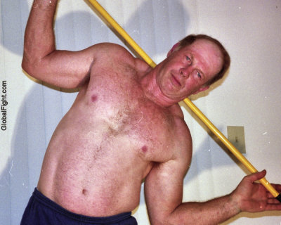 handsome daddy coach stretching stick workout.jpg