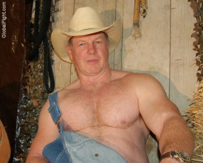 ruggedly handsome farmer sitting haybales pics.jpg