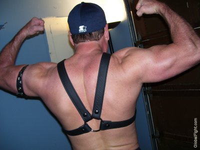 muscledad flexing big deltoids leather gay harness.jpg