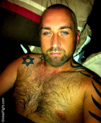 blue eyed hairy bear tats arm tattoed gay dude.jpg