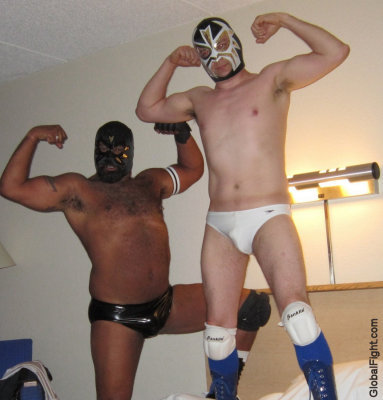 pro wrestlers hotel wrestling guys flexing on bed.jpg
