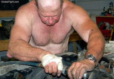 bald mechanic man working shirtless air gun.jpg