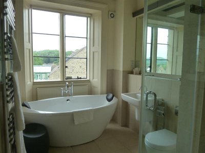 with open plan bathroom - the walls stop short of the ceiling