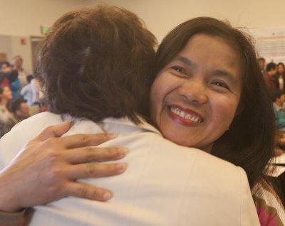 A new citizen gets a hug from Unalaska Mayor Shirley Marquardt