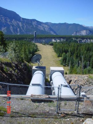 Water pipes from lake to turn turbine( big tower)  for generating electricity