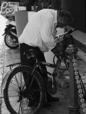 man locking his bicycle