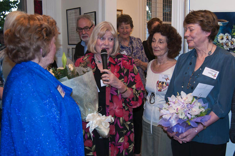 Barb presents flowers to Eleanor on behalf of the group