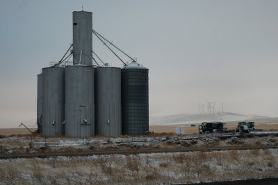 Grain silos with windfarm in background