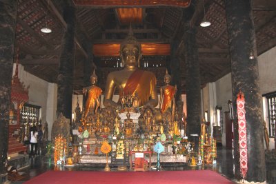 A typical alter with a large seated Buddha inside the Wat Visoun temple.