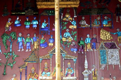 Close-up of the front gable ends which are richly decorated with intricate gold mosaic designs on red ochre background.