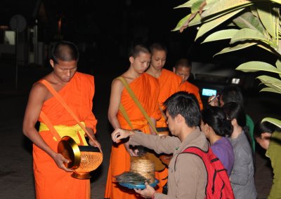 The alms are mostly in the form of sticky rice (khao niaw), bananas and other food.